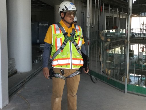 an on construction site properly wearing fall arrest harness