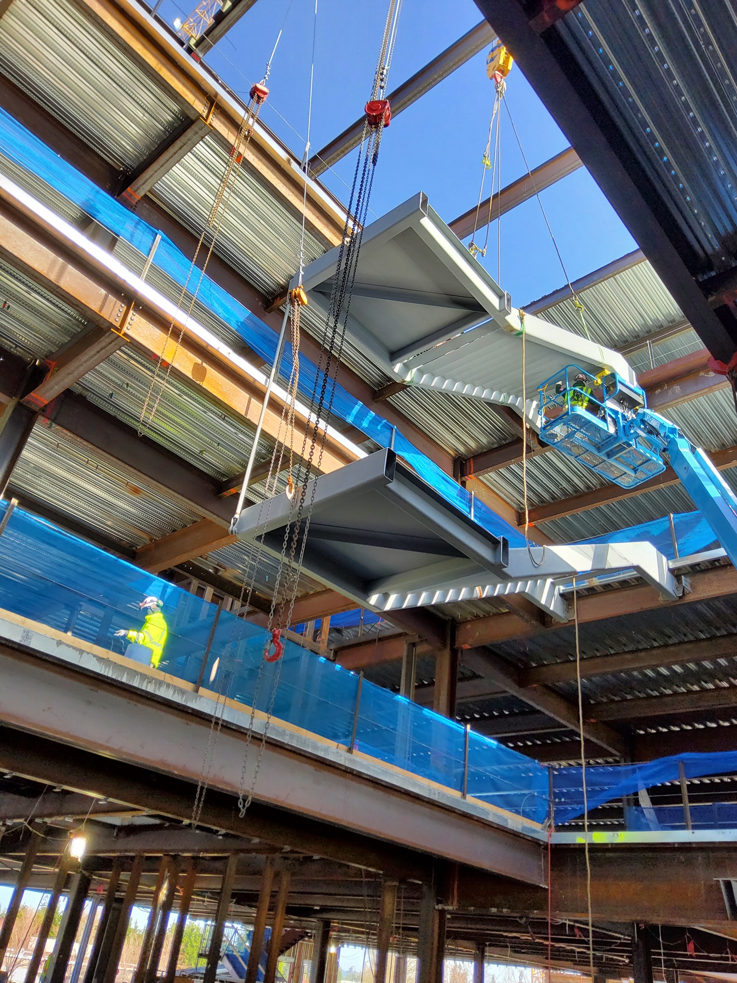 Two prefabricated modular feature stairs being craned into building under construction